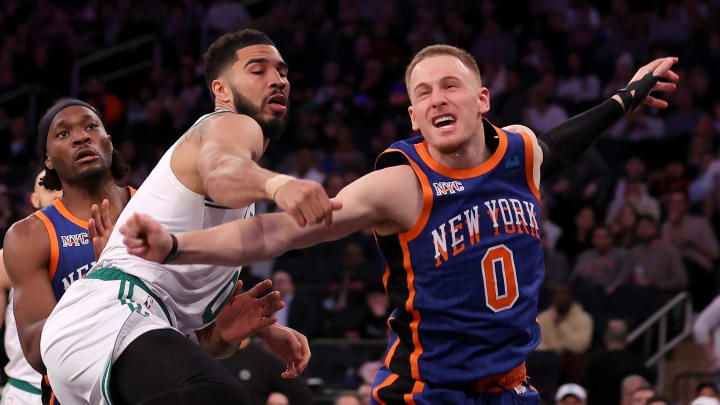 Feb 24, 2024; New York, New York, USA; New York Knicks guard Donte DiVincenzo (0) reacts after his shot is blocked by Boston Celtics forward Jayson Tatum (0) during the third quarter at Madison Square Garden. Mandatory Credit: Brad Penner-USA TODAY Sports