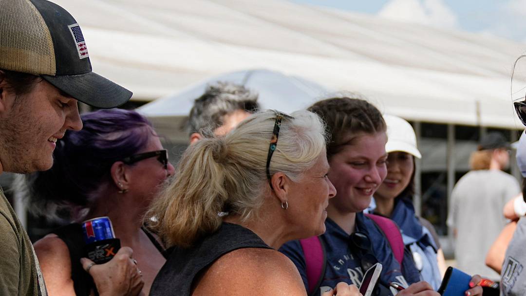 NASCAR Xfinity Series driver Katherine Legge (32) signs autographs with fans Saturday, July 26, 2025, prior to the Pennzoil 250 at Indianapolis Motor Speedway.