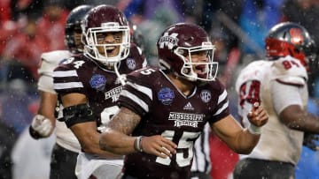 Dec 30, 2015; Charlotte, NC, USA; Mississippi State Bulldogs quarterback Dak Prescott (15) and tight end Darrion Hutcherson (84) celebrate after a touchdown in the second quarter against the North Carolina State Wolfpack in the 2015 Belk Bowl at Bank of America Stadium. Mandatory Credit: Jeremy Brevard-USA TODAY Sports