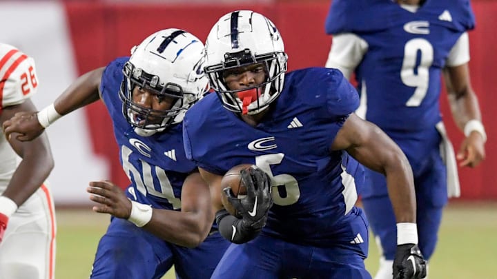 Clay-Chalkville's Taurus Chambers (5) carries the ball against Saraland High School during the AHSAA Class 6A football state championship game at Bryant Denny Stadium in Tuscaloosa, Ala., on Friday December 8, 2023.