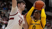 Cal 6-foot-1 guard Jeremiah Wilkinson challenges Stanford's 7-foot-1 Maxime Reynaud