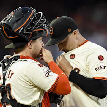 San Francisco Giants catcher Patrick Bailey (14) and starting pitcher Blake Snell (7) talk before a bass-loaded pitch against the Milwaukee Brewers during the second inning at Oracle Park on Sept 11.