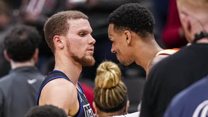 Apr 3, 2024; Atlanta, Georgia, USA; Detroit Pistons guard Malachi Flynn (14) reacts with Atlanta Hawks guard Dejounte Murray (5) after scoring fifty points at State Farm Arena. Mandatory Credit: Dale Zanine-USA TODAY Sports