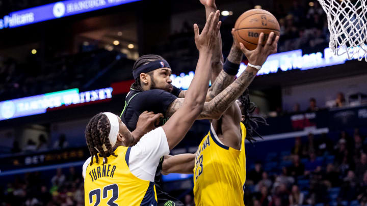 Mar 1, 2024; New Orleans, Louisiana, USA;  New Orleans Pelicans forward Brandon Ingram (14) drives to the basket against Indiana Pacers forward Aaron Nesmith (23) and center Myles Turner (33) during the second half at Smoothie King Center