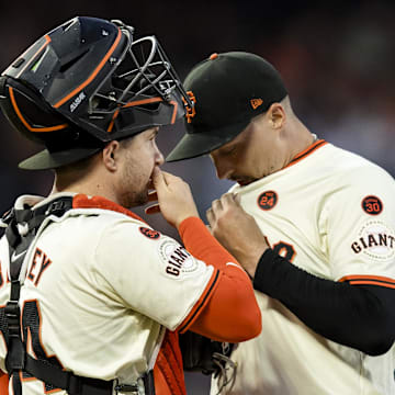 Sep 11, 2024; San Francisco, California, USA; San Francisco Giants catcher Patrick Bailey (14) and starting pitcher Blake Snell (7) talk before a bass-loaded pitch against the Milwaukee Brewers during the second inning at Oracle Park.