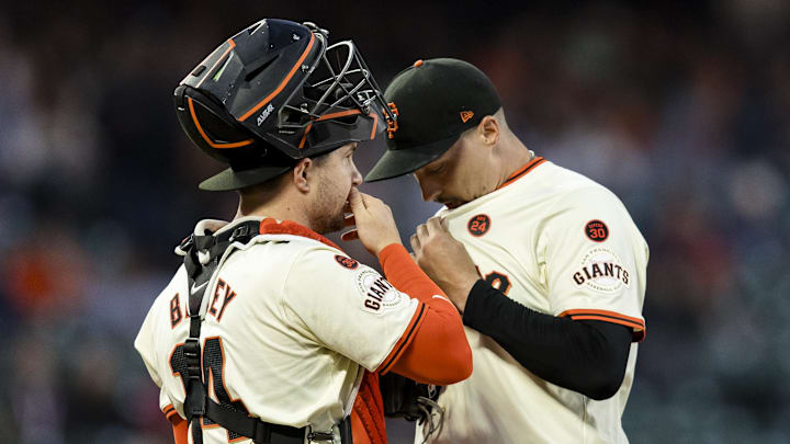 Sep 11, 2024; San Francisco, California, USA; San Francisco Giants catcher Patrick Bailey (14) and starting pitcher Blake Snell (7) talk before a bass-loaded pitch against the Milwaukee Brewers during the second inning at Oracle Park.