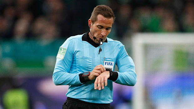 The referee keeps track of stoppage time in soccer.