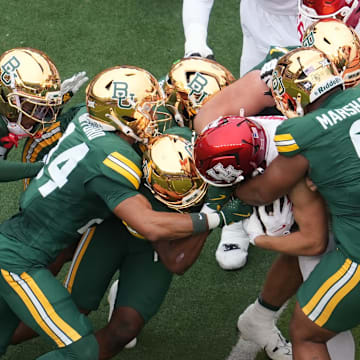 Nov 29, 2025; Waco, Texas, USA; Houston Cougars running back Dean Connors (44) is stopped for a short gain by Baylor Bears defensive lineman Jackie Marshall (0) during the first half at McLane Stadium. Mandatory Credit: Chris Jones-Imagn Images