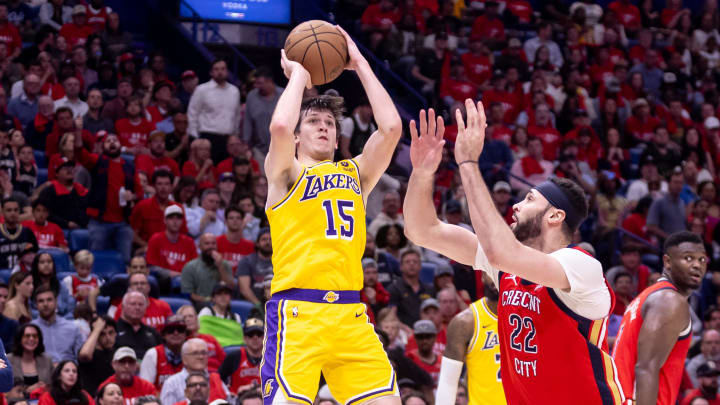 Apr 16, 2024; New Orleans, Louisiana, USA; Los Angeles Lakers guard Austin Reaves (15) shoots against New Orleans Pelicans forward Larry Nance Jr. (22) during the second half of a play-in game of the 2024 NBA playoffs at Smoothie King Center. Mandatory Credit: Stephen Lew-USA TODAY Sports