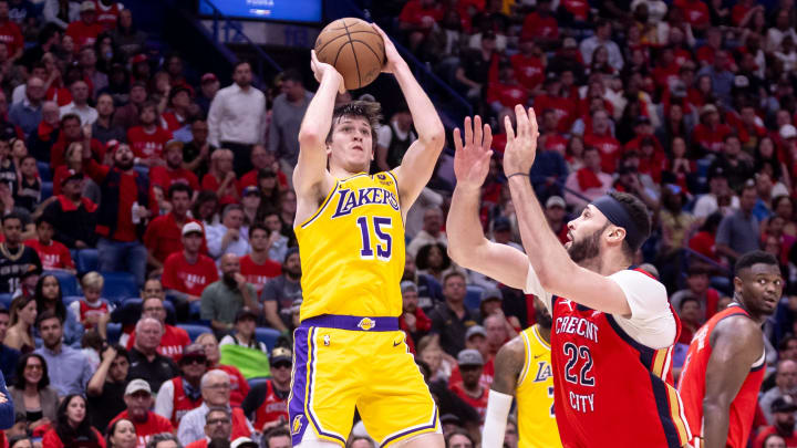 Apr 16, 2024; New Orleans, Louisiana, USA; Los Angeles Lakers guard Austin Reaves (15) shoots against New Orleans Pelicans forward Larry Nance Jr. (22) during the second half of a play-in game of the 2024 NBA playoffs at Smoothie King Center. Mandatory Credit: Stephen Lew-USA TODAY Sports