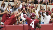 Aug 31, 2024; Tuscaloosa, Alabama, USA;  Alabama Crimson Tide quarterback Jalen Milroe (4) celebrates with fans after scoring against the Western Kentucky Hilltoppers during the first half at Bryant-Denny Stadium.  Mandatory Credit: Gary Cosby Jr.-USA TODAY Sports