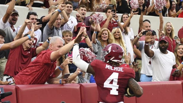 Alabama quarterback Jalen Milroe celebrates with fans.