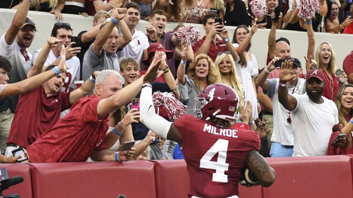 Aug 31, 2024; Tuscaloosa, Alabama, USA;  Alabama Crimson Tide quarterback Jalen Milroe (4) celebrates with fans after scoring against the Western Kentucky Hilltoppers during the first half at Bryant-Denny Stadium.  Mandatory Credit: Gary Cosby Jr.-USA TODAY Sports