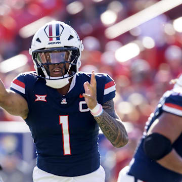Nov 8, 2025; Tucson, Arizona, USA; Arizona Wildcats quarterback Noah Fifita (1) throws a touchdown pass against the Kansas Jayhawks in the first half at Arizona Stadium. Mandatory Credit: Mark J. Rebilas-Imagn Images