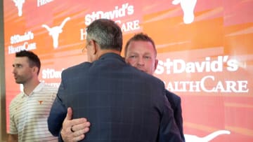 University of Texas baseball coach Jim Schlossnagle hugs Athletic Director Chris Del Conte at his introductory news conference at the Frank Denius Family University Hall of Fame Wednesday June 26, 2024.