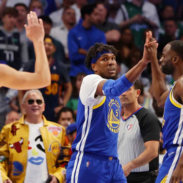 May 24, 2022; Dallas, Texas, USA; Golden State Warriors center Kevon Looney (5) high fives forward Draymond Green (23) after a play against the Dallas Mavericks during the first quarter in game four of the 2022 Western Conference finals at American Airlines Center. 