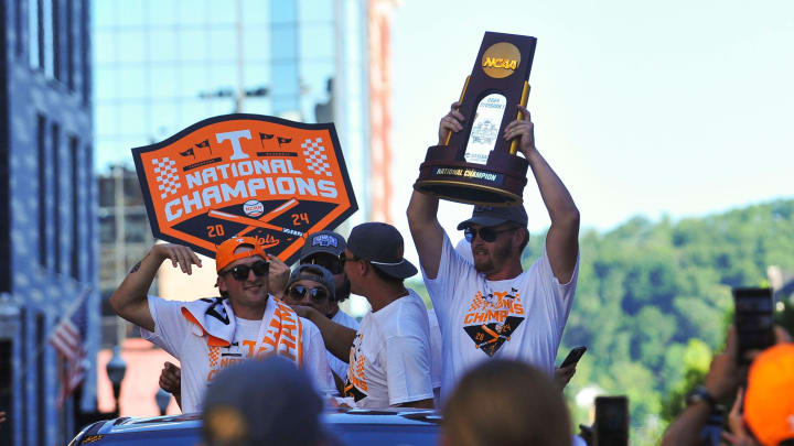 Tennessee's Blake Burke (25) holds up the NCAA baseball trophy during the NCAA Baseball National Championship parade in Downtown Knoxville on Tuesday, June 25, 2024.
