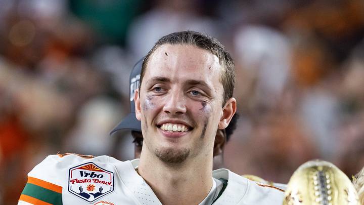Jan 8, 2026; Glendale, AZ, USA; Miami Hurricanes quarterback Carson Beck (11) celebrates with the trophy after defeating the Mississippi Rebels during the 2026 Fiesta Bowl and semifinal game of the College Football Playoff at State Farm Stadium. Mandatory Credit: Mark J. Rebilas-Imagn Images