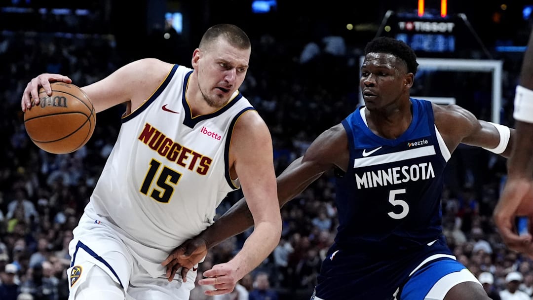 Mar 12, 2025; Denver, Colorado, USA; Minnesota Timberwolves guard Anthony Edwards (5) defends Denver Nuggets center Nikola Jokic (15) in the second half at Ball Arena.
