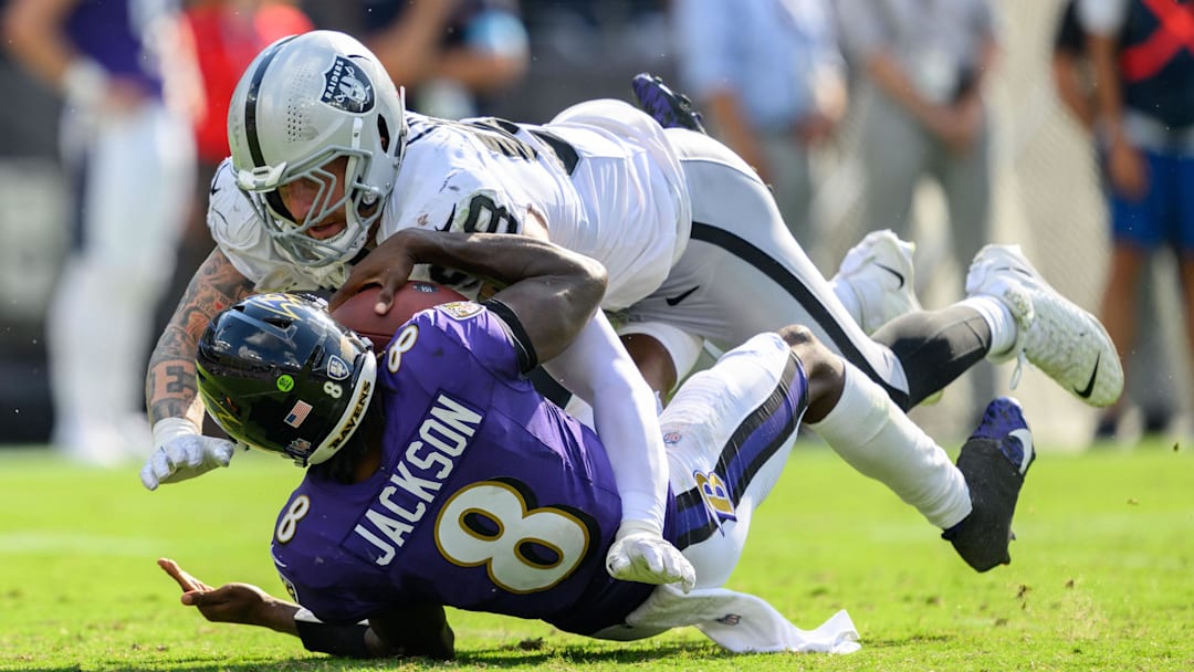 Sep 15, 2024; Baltimore, Maryland, USA; Las Vegas Raiders defensive end Maxx Crosby (98) sacks Baltimore Ravens quarterback Lamar Jackson (8) during the second half at M&T Bank Stadium. Mandatory Credit: Reggie Hildred-Imagn Images