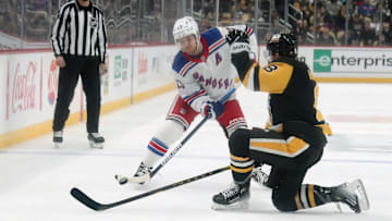 Alexis Lafreniere plays the puck against the Pittsburgh Penguins; Mandatory Credit: Charles LeClaire-Imagn Images