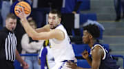 Delaware's John Camden (left) works against Monmouth's Madison Durr