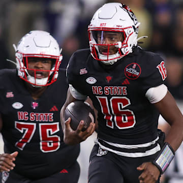 Nov 21, 2024; Atlanta, Georgia, USA; North Carolina State Wolfpack quarterback CJ Bailey (16) runs for a touchdown against the Georgia Tech Yellow Jackets in the fourth quarter at Bobby Dodd Stadium at Hyundai Field. Mandatory Credit: Brett Davis-Imagn Images