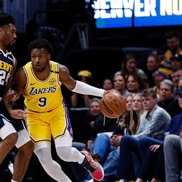 Mar 14, 2025; Denver, Colorado, USA; Los Angeles Lakers guard Bronny James Jr. (9) controls the ball as Denver Nuggets guard Jalen Pickett (24) guards in the first quarter at Ball Arena. Mandatory Credit: Isaiah J. Downing-Imagn Images