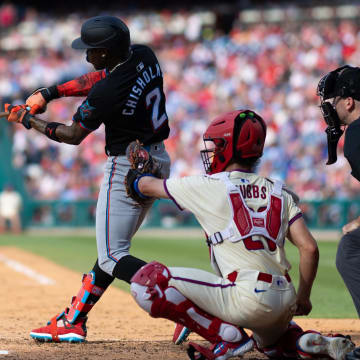 Jun 29, 2024; Philadelphia, Pennsylvania, USA; Miami Marlins outfielder Jazz Chisholm Jr. (2) hits an RBI single during the seventh inning against the Philadelphia Phillies at Citizens Bank Park. 