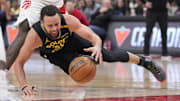 Warriors guard Stephen Curry hits the deck for a loose ball after getting tripped up/