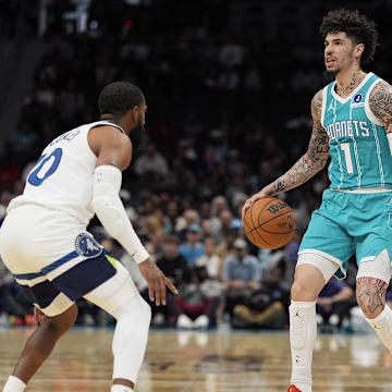 Nov 1, 2025; Charlotte, North Carolina, USA; Charlotte Hornets guard LaMelo Ball (1) sets the play defended by Minnesota Timberwolves guard Mike Conley (10) during the first quarter at Spectrum Center. Mandatory Credit: Jim Dedmon-Imagn Images