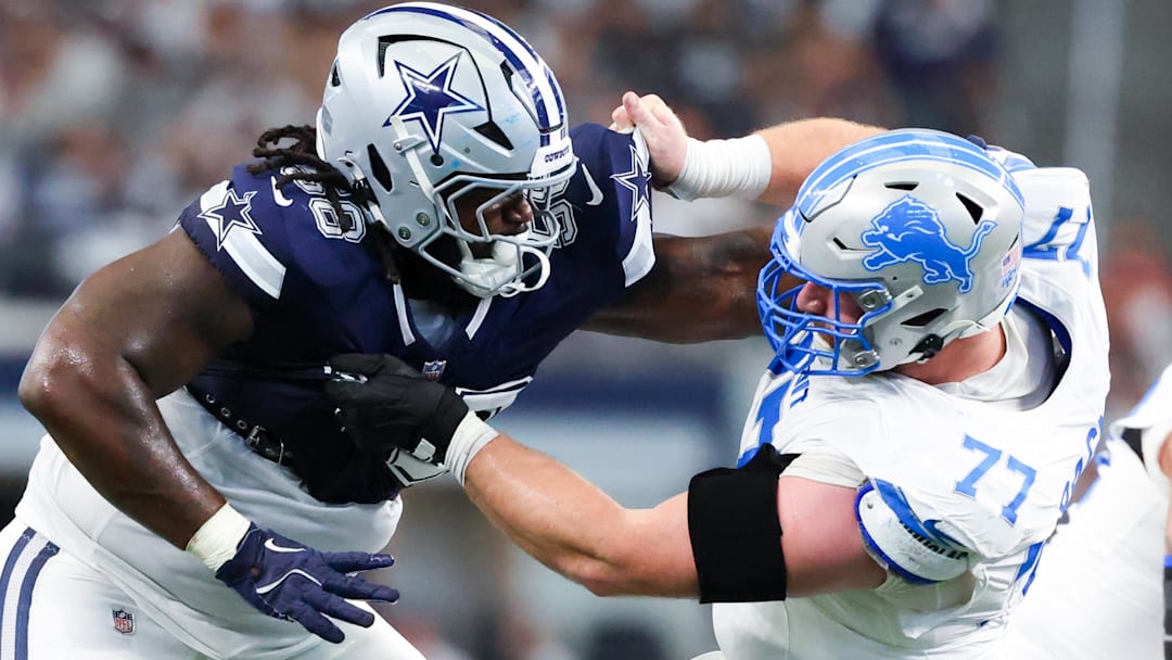 Oct 13, 2024; Arlington, Texas, USA;  Dallas Cowboys defensive tackle Mazi Smith (58) and Detroit Lions center Frank Ragnow (77) battle during the second quarter at AT&T Stadium.