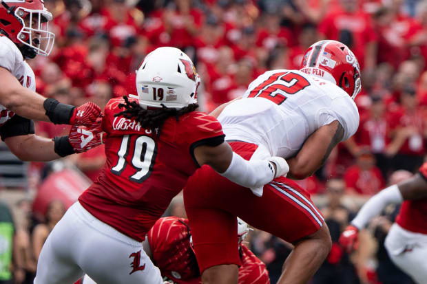 Louisville Cardinals defensive lineman Tramel Logan (19) tackles Austin Peay Governors quarterback Mason Garcia (12)