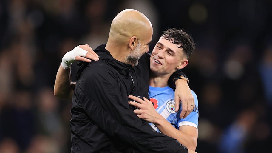 Pep Guardiola (left) hugging Phil Foden.