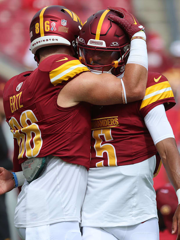 Washington Commanders quarterback Jayden Daniels (5) and tight end Zach Ertz (