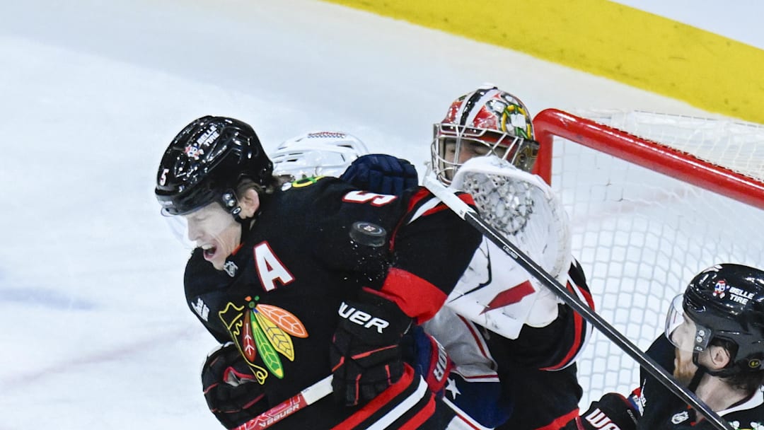 Jan 30, 2026; Chicago, Illinois, USA;  The puck hits Chicago Blackhawks defenseman Connor Murphy (5) as Columbus Blue Jackets center Kent Johnson (91) and  Elvis Merzlikins (90) defend during the third period at the United Center. Mandatory Credit: Matt Marton-Imagn Images