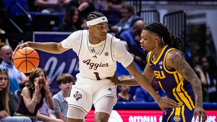 Mar 8, 2025; Baton Rouge, Louisiana, USA;  Texas A&M Aggies guard Zhuric Phelps (1) dribbles against LSU Tigers guard Jordan Sears (1) during the first half at Pete Maravich Assembly Center. Mandatory Credit: Stephen Lew-Imagn Images