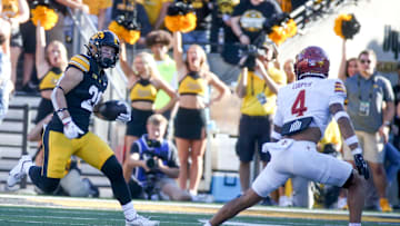 Iowa’s Kaden Wetjen (21) runs the ball as Iowa State’s Jeremiah Cooper (4) defends during the Cy-Hawk game Saturday, Sept. 7, 2024 at Kinnick Stadium in Iowa City, Iowa.