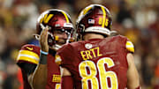 Dec 29, 2024; Landover, Maryland, USA; Washington Commanders quarterback Jayden Daniels (5) celebrates with Commanders tight end Zach Ertz (86) after connecting on a touchdown pass against the Atlanta Falcons during the third quarter at Northwest Stadium. Mandatory Credit: Geoff Burke-Imagn Images