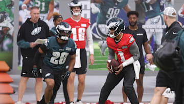 May 28, 2025; Philadelphia, PA, USA; Philadelphia Eagles quarterback Jalen Hurts (1) hands off to running back Saquon Barkley (26) during OTAs at NovaCare Complex. Mandatory Credit: Bill Streicher-Imagn Images