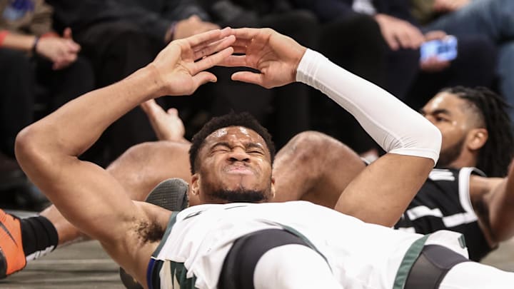 Milwaukee Bucks forward Giannis Antetokounmpo reacts after falling to the floor in the first quarter against the Brooklyn Nets at Barclays Center on October 27, 2024.