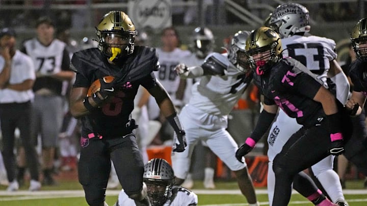 Basha's Noah Roberts avoids a tackle by Hamilton's Derrick Leblanc Jr. during a football game at Basha High School in Chandler on Oct. 11, 2024.