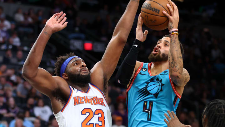 Nov 20, 2022; Phoenix, Arizona, USA; Phoenix Suns guard Duane Washington Jr. (4) drives to the basket against New York Knicks center Mitchell Robinson (23) in the first half at Footprint Center. Mandatory Credit: Mark J. Rebilas-USA TODAY Sports