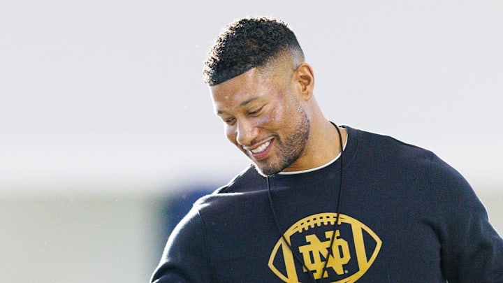 Notre Dame head coach Marcus Freeman greets his players during a Notre Dame football spring practice.