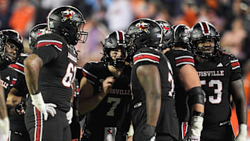 Louisville Cardinals quarterback Miller Moss (7) huddles with his offensive line late in the fourth quarter against Clemson during the Cards 20-19 loss at L&N Stadium in Louisville, Kentucky Friday, Nov. 14, 2025.