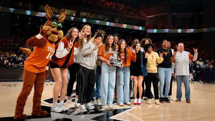 The University of Texas Women's Basketball Team present their Big 12 Championship Trophy during the first quarter of the Spurs' I-35 series game at Moody Center in Austin, Friday March 15, 2024.