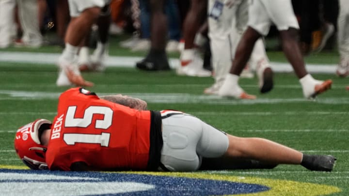 Georgia quarterback Carson Beck (15) goes down after a hit on this trowing shoulder during the first half of the SEC championship game against Texas in Atlanta, on Saturday, Dec. 7, 2024. Georgia quarterback Carson Beck (15) goes down after a hit on this trowing shoulder during the first half of the SEC championship game against Texas in Atlanta, on Saturday, Dec. 7, 2024.