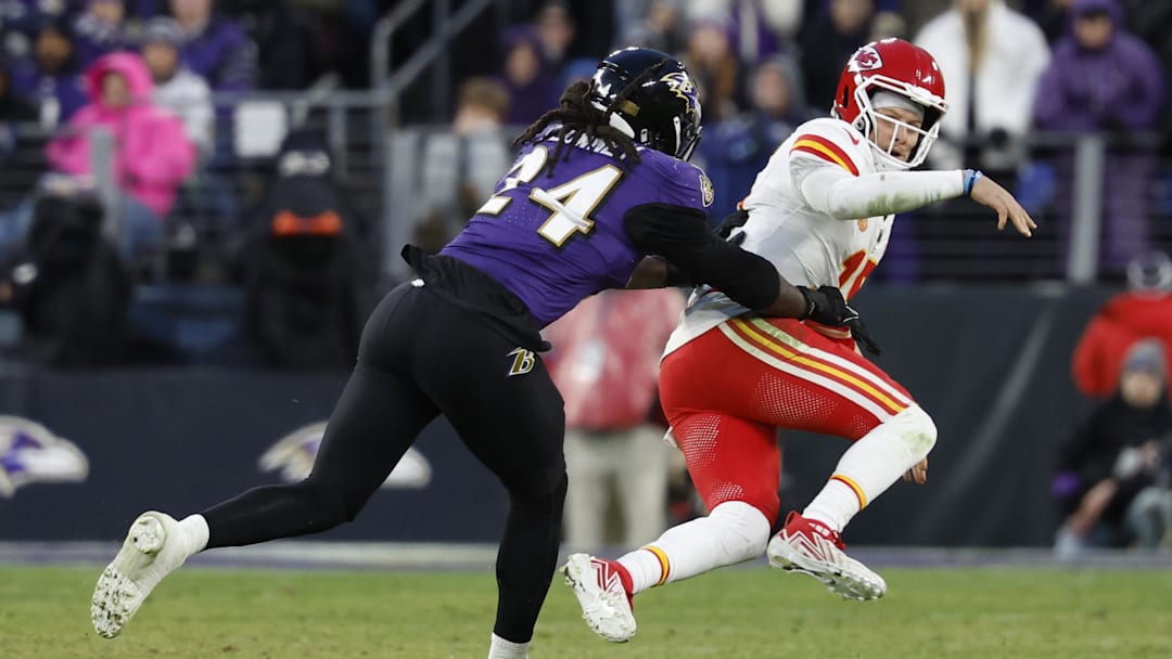 Jan 28, 2024; Chiefs quarterback Patrick Mahomes (15) is knocked down by Baltimore Ravens linebacker Jadeveon Clowney.