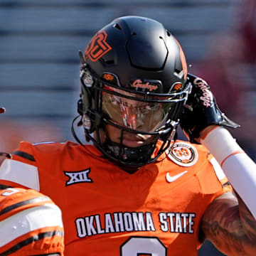 Oklahoma State's Ollie Gordon II (0) warms up before the college football game between the Oklahoma State Cowboys and the Arkansas Razorbacks at Boone Pickens Stadium in Stillwater, Okla.,, Saturday, Sept., 7, 2024.