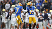 Pittsburgh Panthers defensive back Rashad Battle (15) celebrates breaking up a pass with Pittsburgh Panthers defensive back Javon McIntyre (7) during the first half against the Notre Dame Fighting Irish at Acrisure Stadium in Pittsburgh, PA on November 15, 2025.